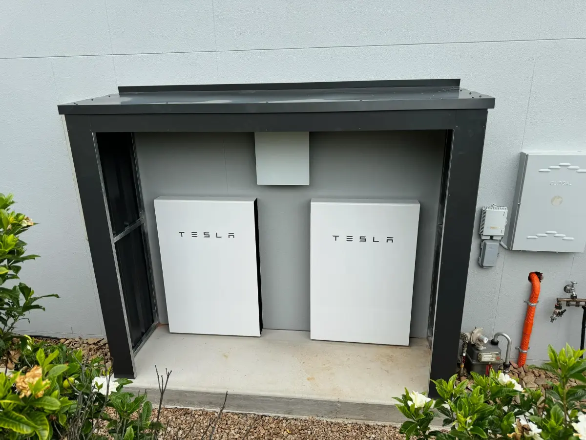 Two Tesla Powerwall batteries in a purpose-built enclosure, installed by CES