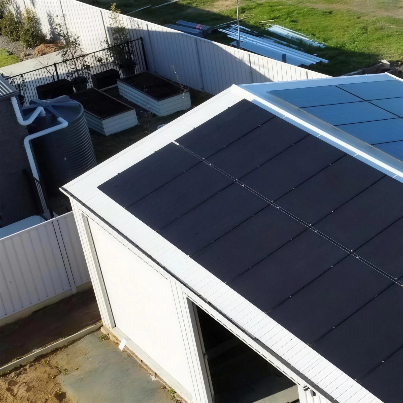 Black solar panels across a new shed roof, installed by CES